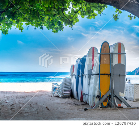Row of locked and stacked surfboards at a beach resort in Waikiki, Hawaii in the morning.  126797430