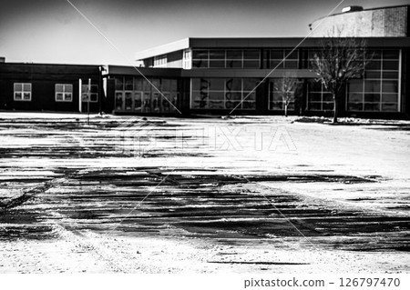 Snow covered parking lot with the lines covered in some locations. 126797470