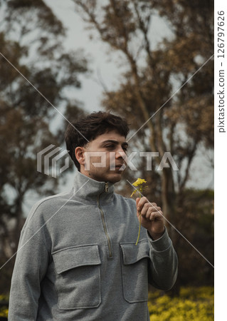 Man Selecting And Picking Yellow Flowers From The Ground  126797626