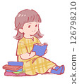 A woman in a yellow dress reading a book 126798210