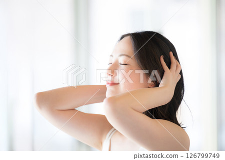 Beauty image of a beautiful woman doing hair care 126799749