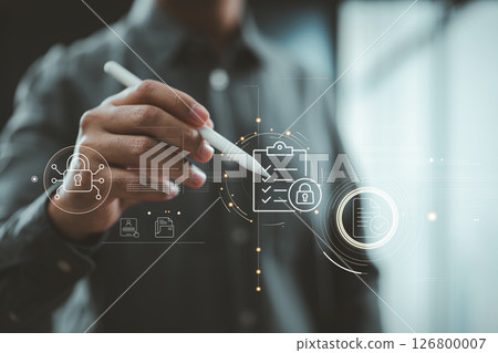 Hand holding stylus interacting with digital checklist and security lock icons on futuristic interface. Hand holding stylus interacting with digital checklist and security lock icons on futuristic interface. 126800007