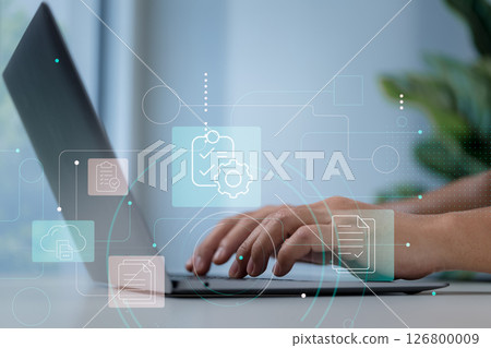 Close-up of hands typing on laptop with overlay of checklist and gear icons for document automation. Close-up of hands typing on laptop with overlay of checklist and gear icons for document automation. 126800009