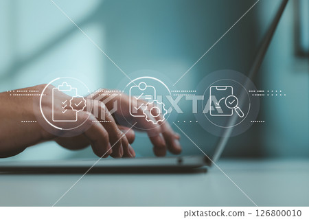 Digital document review and approval interface floating above typing hands on modern laptop. 126800010