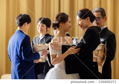 Bride and mother embracing 126800251