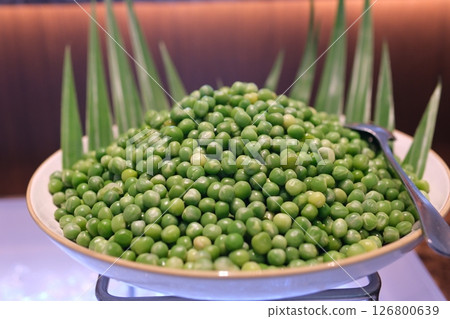 Green peas bowl Plate of fresh, ripe, juicy green pea whirl. 126800639