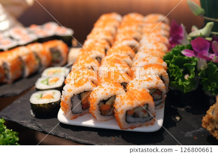 Sushi rolls platter Slow motion close-up of plated sushi rolls as white sauce is drizzled over top Sushi rolls platter Slow motion close-up of plated sushi rolls as white sauce is drizzled over top 126800661