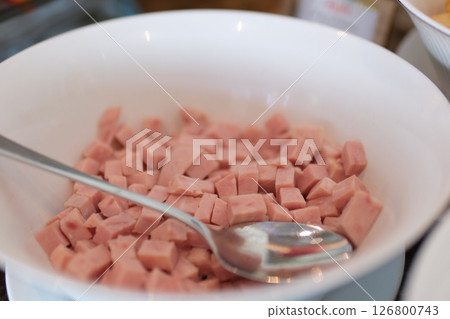 cooked sausage mortadella cubes on a white background withspoon plate cooked sausage mortadella cubes on a white background withspoon plate 126800743