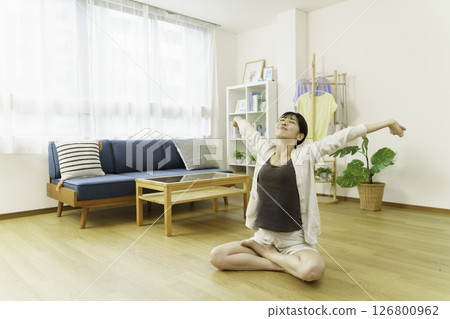 A young woman stretching in the living room A young woman stretching in the living room 126800962
