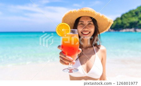 Woman in swimsuit holding cocktail 126801977