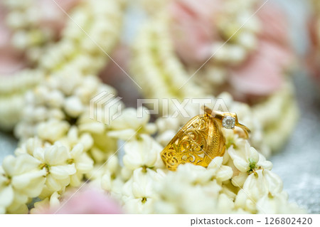 Gold ring , Wedding ring,Diamond ring on the flowers. Gold ring , Wedding ring,Diamond ring on the flowers. 126802420