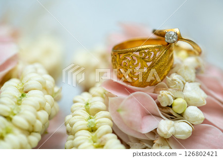 Gold ring , Wedding ring,Diamond ring on the flowers. Gold ring , Wedding ring,Diamond ring on the flowers. 126802421