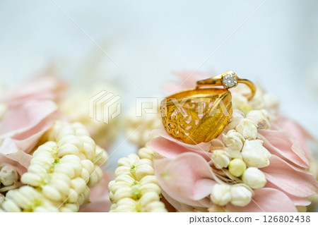 Gold ring , Wedding ring,Diamond ring on the flowers. Gold ring , Wedding ring,Diamond ring on the flowers. 126802438