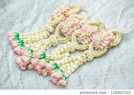 Beautiful Thai-style jasmine garland on a silver cloth background with an ancient Thai pattern. 126802503