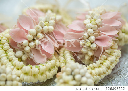 Beautiful Thai-style jasmine garland on a silver cloth background with an ancient Thai pattern. 126802522