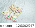 Beautiful Thai-style jasmine garland on a silver cloth background with an ancient Thai pattern. 126802547