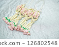 Beautiful Thai-style jasmine garland on a silver cloth background with an ancient Thai pattern. 126802548