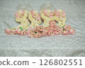 Beautiful Thai-style jasmine garland on a silver cloth background with an ancient Thai pattern. 126802551