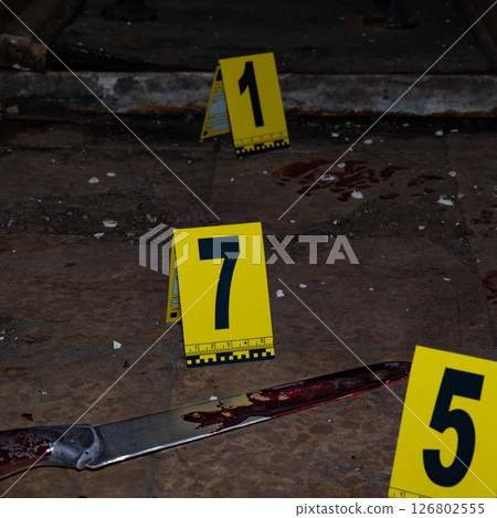 Bloody handprint and bloody knife at crime scene with yellow evidence marker. High quality photo Bloody handprint and bloody knife at crime scene with yellow evidence marker. High quality photo 126802555