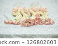 Beautiful Thai-style jasmine garland on a silver cloth background with an ancient Thai pattern. 126802603