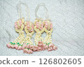 Beautiful Thai-style jasmine garland on a silver cloth background with an ancient Thai pattern. 126802605