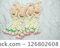 Beautiful Thai-style jasmine garland on a silver cloth background with an ancient Thai pattern. 126802608