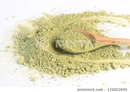 Japanese powdered matcha green tea on wooden spoon. Antioxidant, healthy, organic product. Beverages and nutrition. Isolated image on white background. Japanese powdered matcha green tea on wooden spoon. Antioxidant, healthy, organic product. Beverages and nutrition. Isolated image on white background. 126802609