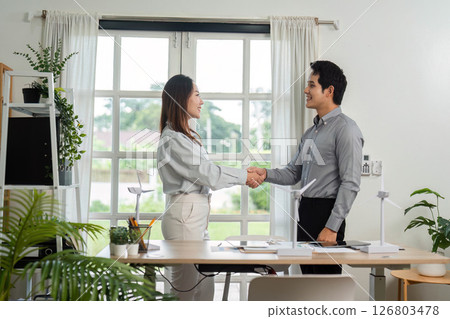 ESG Business Partnership. Professionals shaking hands after successful sustainability project. 126803478