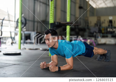 Fitness: Man Performing Plank Exercise in Gym 126803515