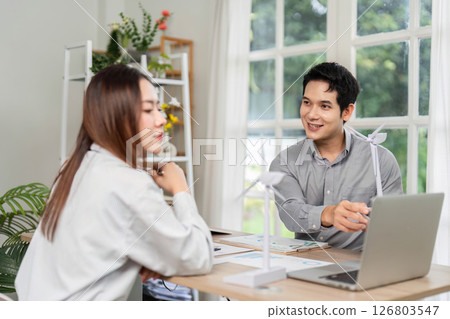 ESG Focused Discussion. Business professionals collaborating on renewable energy projects in a bright office. 126803547