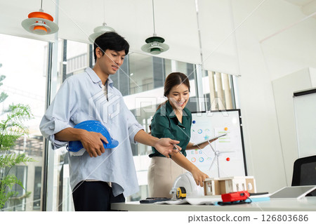 Innovative Engineering Collaboration. Engineers working on sustainable building projects. 126803686