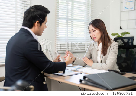 Professional Financial Meeting. Client and advisor discussing financial plans and goals. Professional Financial Meeting. Client and advisor discussing financial plans and goals. 126803751