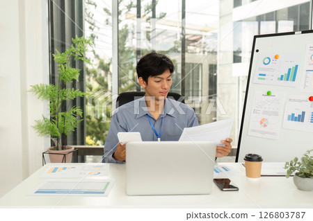 Business Analysis and Reporting. Professional reviewing documents in modern office. Business Analysis and Reporting. Professional reviewing documents in modern office. 126803787