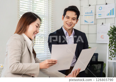 Financial Document Review. Business partners sharing insights on financial reports in an office. Financial Document Review. Business partners sharing insights on financial reports in an office. 126803790