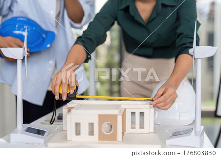 An engineer measuring a model for a sustainable architecture Engineering for Sustainable Architecture. 126803830
