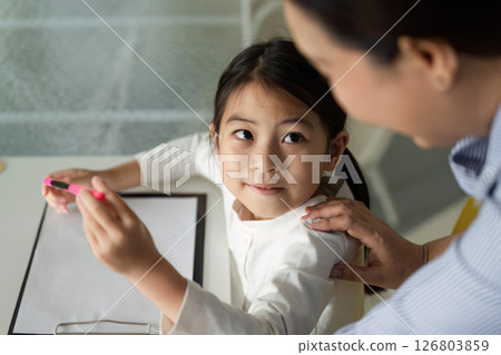 Back to School. Young girl focused on her work during a classroom session. 126803859