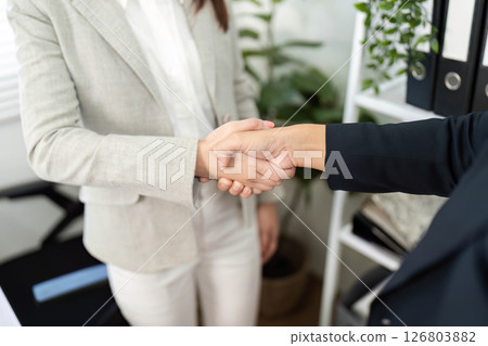 Financial Empowerment. Close-up of a handshake between business partners in an office. Financial Empowerment. Close-up of a handshake between business partners in an office. 126803882