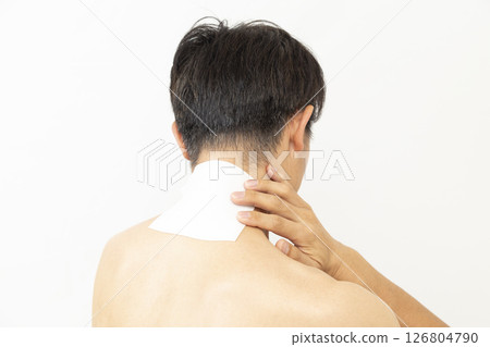 Back view of a man with a compress on his neck, white background 126804790