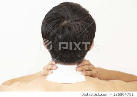 Back view of a man with a compress on his neck, white background 126804791
