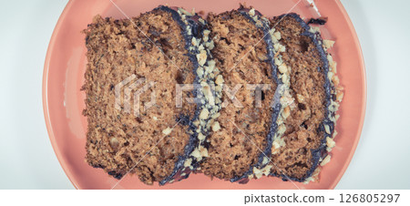 Pastry made of zucchini with nuts and raisin. Delicious dessert. White background 126805297