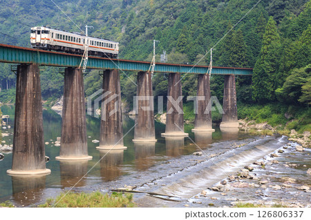 The Takayama Main Line crossing the impressive No. 1 Hida River Bridge with its powerful piers 126806337