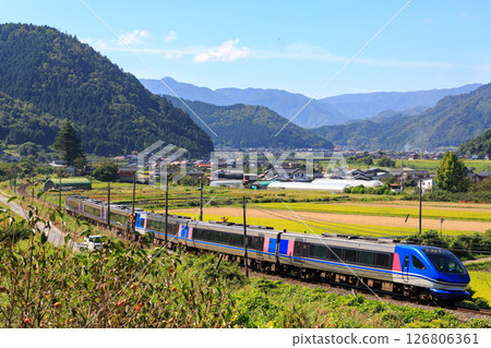 An express train on the Inbi Line passes through the railroad crossing at Kuniei An express train on the Inbi Line passes through the railroad crossing at Kuniei 126806361