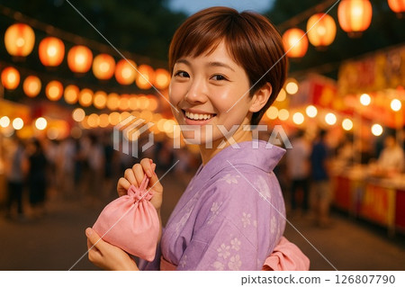 A short-haired Japanese woman turns around at a festival 126807790