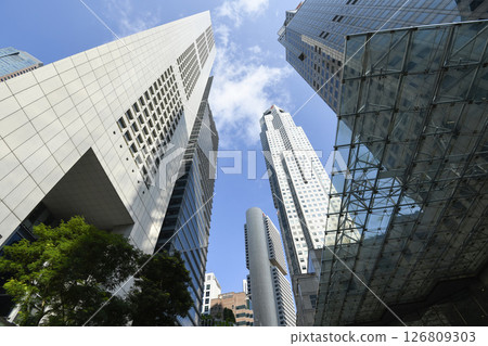 Low-angle building view of the modern office skyscrapers in the financial district of Raffles Place, Singapore. Low-angle building view of the modern office skyscrapers in the financial district of Raffles Place, Singapore. 126809303