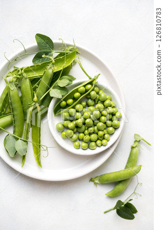 Fresh green peas beans in a white plate, copy space Fresh green peas beans in a white plate, copy space 126810783