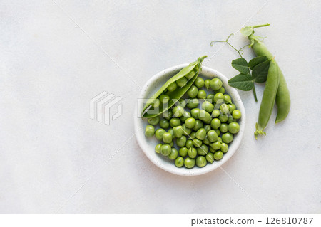 Fresh green peas beans in a white plate, copy space Fresh green peas beans in a white plate, copy space 126810787
