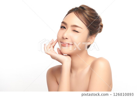 A beautiful young Asian woman with clean, fresh skin against a white background. Skincare, facial treatment, cosmetology, beauty, and spa. An elegant portrait of an Asian woman. 126810893