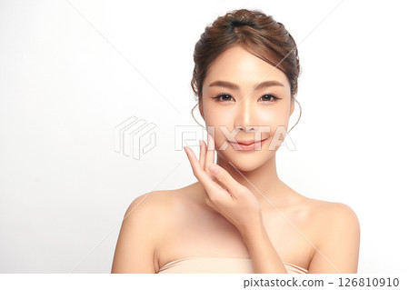 A beautiful young Asian woman with clean, fresh skin against a white background. Skincare, facial treatment, cosmetology, beauty, and spa. An elegant portrait of an Asian woman. 126810910