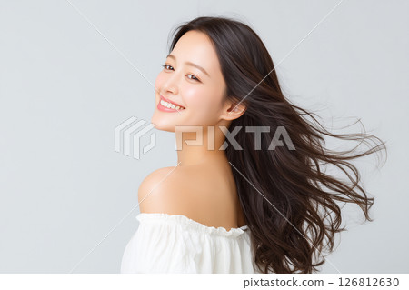 A woman in a white off-shoulder top and a refreshing smile 126812630