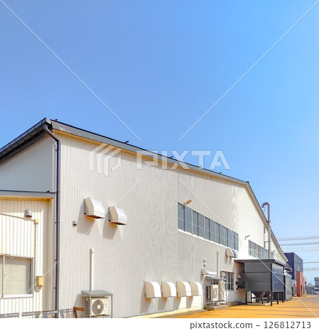Factory with white exterior and blue sky Factory with white exterior and blue sky 126812713
